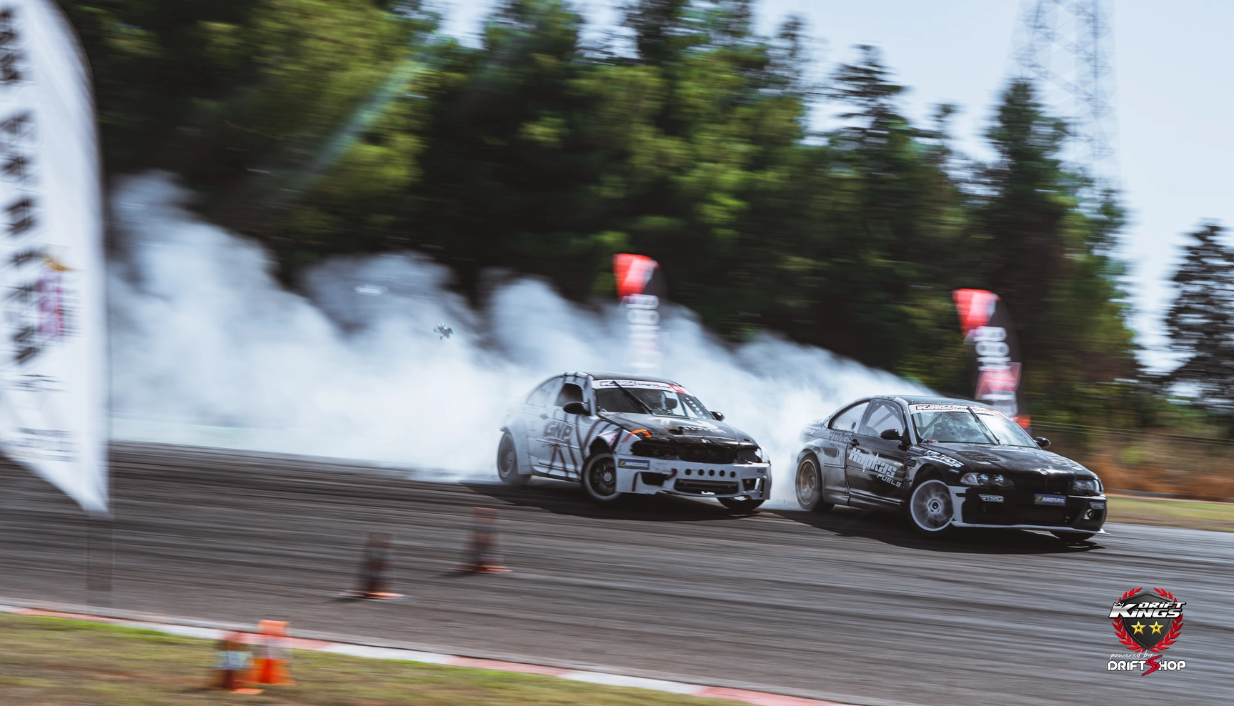 A Mercedes SL and BMW in a tandem drift battle at Serres Racing Circuit